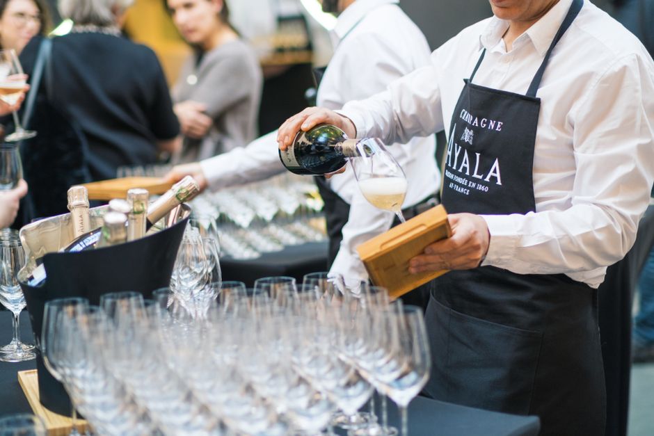 Waiter pouring champagne at a corporate catering event